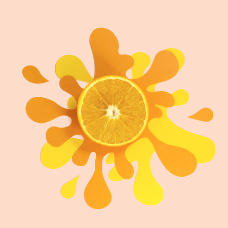 Slice of juicy orange on paper napkin in form of splash and spray. Delicious juicy fruits. Creative minimal food conceptの写真素材