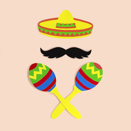 Symbols of Cinco de Mayo sombrero, mustache and maracas made of paper. Cinco de Mayo is federal holiday in Mexico on May 5th. Paper art and craft. Minimal holiday concept. Space for textの写真素材
