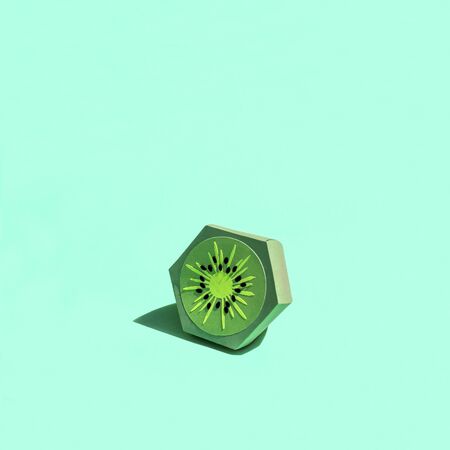 Paper kiwi with shade in bright sunshine. Paper art and craft. Trendy hobby. Minimal artistic food concept. Copy spaceの写真素材