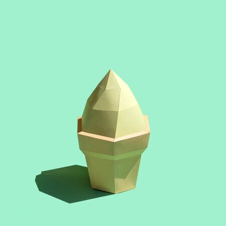 Paper ice cream in waffle cup in bright sunshine. Volumetric handmade paper objects. Paper art and craft. Trendy hobby. Minimal artistic food concept. Copy spaceの写真素材