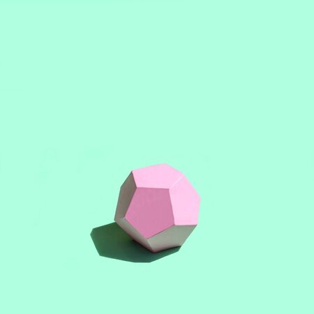 Paper pink dodecahedron in bright sunshine. Volumetric handmade paper objects. Paper art and craft. Trendy hobby. Minimal artistic conceptの写真素材