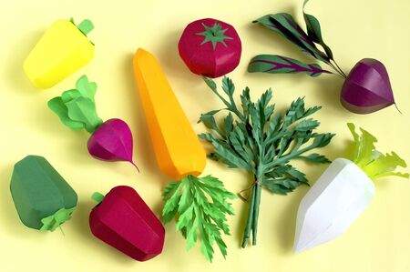 Colorful set of paper vegetables on yellow background. Paper art and craft. Trendy hobby. Creative, vegetarian, healthy or food art conceptの写真素材