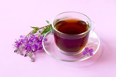 Useful herbal tea from fermented leaves fireweed (Chamerion angustifolium) also known as great willowherb or rosebay willowherb on pink background. Traditional Russian Koporye Tea (Ivan Chai)の写真素材
