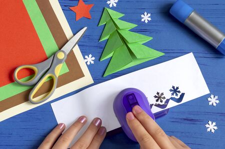 How to make Christmas card with Christmas tree. Original children's art project. DIY concept. Step-by-step photo instructions. Step 8. Cut decorationsの写真素材