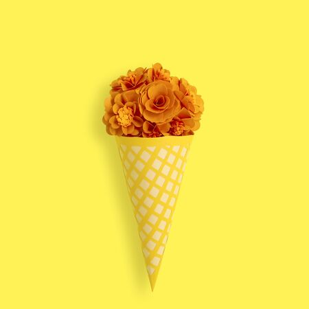 Paper waffle cone with flowers. Elegant voluminous paper decorations for birthday, anniversary, wedding. Paper art and craft. Trendy hobby. Minimal decorative holiday conceptの写真素材