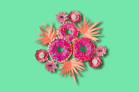 Paper donuts with pink icing and pink leaves. Volumetric handmade paper objects. Summer design. Paper art and craft. Trendy hobby. Minimal art food concept. Copy spaceの写真素材