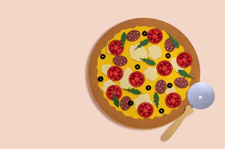 Paper pizza with sausage, olives and pizza knife. Traditional italian pizza in paper art. Volumetric handmade paper objects. Paper art and craft. Trendy hobby. Minimal art food conceptの写真素材