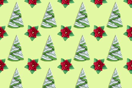 Background of paper poinsettia flowers and Christmas trees. Paper art and craft in festive design. Volumetric paper handmade objectsの写真素材