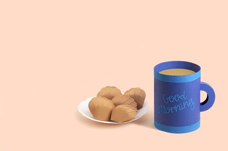 Paper mug with tea and plate with madeleine. Popular french small shell-shaped cake. Paper art and craft. Volumetric handmade paper objects. Minimal art food conceptの写真素材