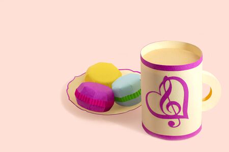 Paper mug and plate with multi-colored macaroons. Popular french dessert for tea. Paper art and craft. Volumetric handmade paper objects. Minimal art food conceptの写真素材