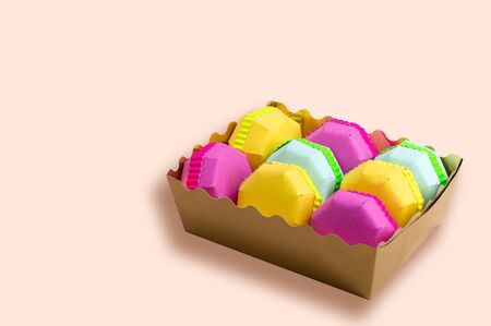 Set of various multicolored macaroons made of paper. Popular french dessert. Sweet macaroons in gift box. Paper art and craft. Volumetric handmade paper objects. Minimal art food conceptの写真素材