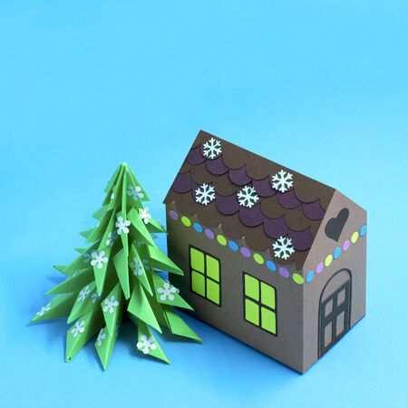 Paper gingerbread house and Christmas tree. Paper art and craft in festive design. Volumetric handmade paper objects. Minimal christmas concept. Square imageの写真素材