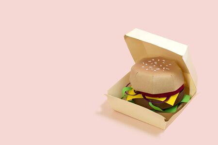 Paper hamburger in box. Volumetric handmade paper objects. Paper art and craft. Trendy hobby. Minimal artistic food concept. Copy spaceの写真素材