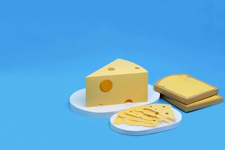 Paper toasts, triangular piece and slices of Maasdam cheese. Dairy products made from paper. Paper art and craft. Volumetric handmade paper objects. Minimal artistic food conceptの写真素材