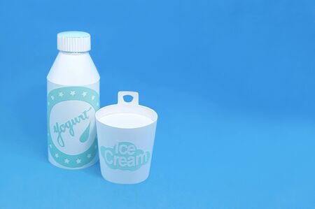 Various dairy products made of paper. Paper bottles with yogurt and ice cream box. Paper art and craft. Real volumetric handmade paper objects. Minimal artistic food conceptの写真素材