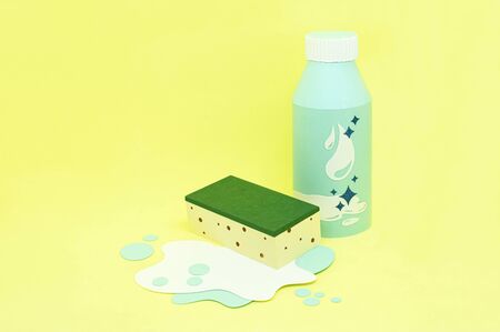 Paper bottle with detergent and sponge in puddle of water and soapy foam. Paper craft and paper art. Real voluminous handmade paper objects. Minimal art cleaning service concept. Copy spaceの写真素材