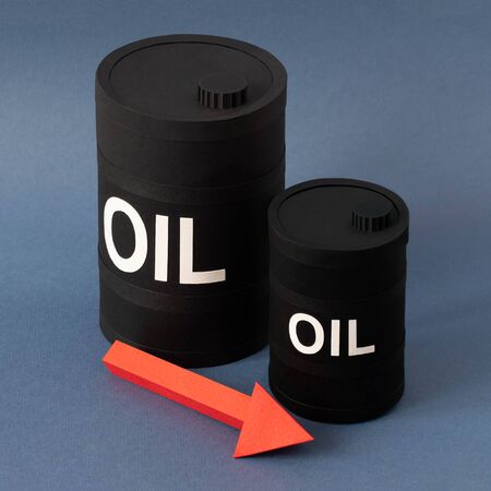 Large and small barrels of oil with arrow showing decrease. Concept to reduce production or oil...