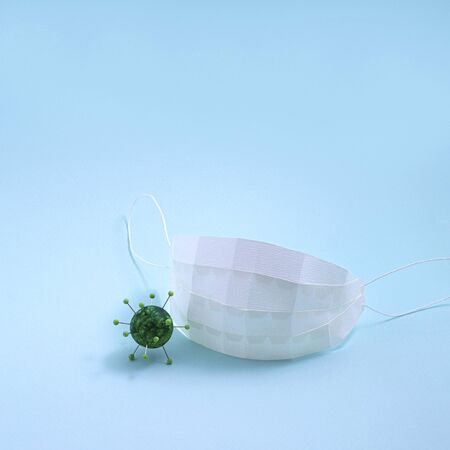 Medical respiratory mask protects against coronavirus. Mask and imitation of coronavirus is made of paper. Real volumetric handmade paper objects. Creative presentation of informationの写真素材