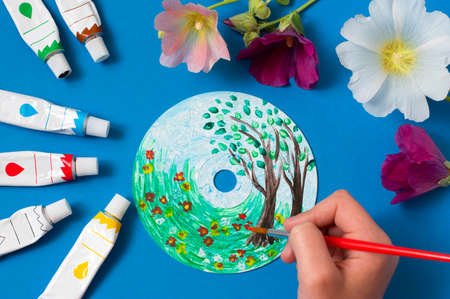 Painting with acrylics paints on CD. Seasons. Summer landscape. Creative art projectの写真素材