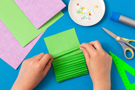 How to make Christmas card with volumetric tree. Original project for children. DIY concept. Step-by-step photo instructions. Step Step 3. Fold sheet of paper in zigzagの写真素材