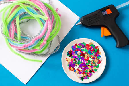 Child makes Christmas tree from chenille wire. Original art project for children. DIY concept. Step by step photo instruction. Step 1. Preparation of materials and toolsの写真素材