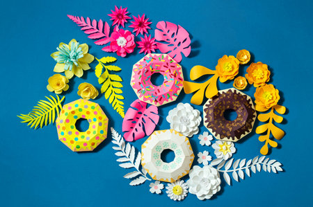 Multicolored paper donuts, flowers and leaves. Handmade volumetric paper objects. Paper art and craft. Flat layの写真素材