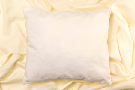 White pillow mockup on soft fabric background with waves. Clean white pillow, bedding design mockup. Blank surface, top view, copy spaceの写真素材