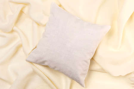 White pillow mockup on soft fabric background with waves. Clean white pillow, bedding design mockup. Blank surface, top view, copy spaceの写真素材