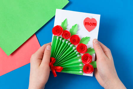 Child makes greeting card for Mother's Day. Art project for children. DIY concept. Step-by-step photo instruction. Step 17. Final resultの写真素材