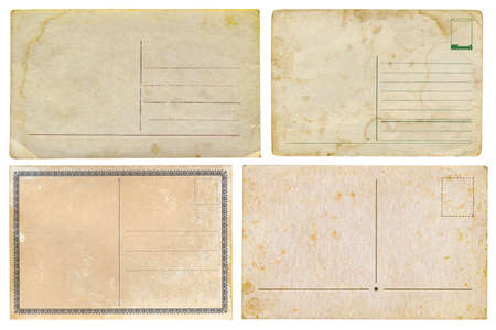 Set of old yellowed cards with stains and damages, isolated on white background. Vintage collection of postcards. Mockup for scrapbooking or vintage designの写真素材