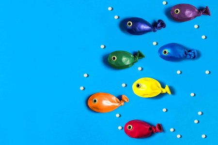 Funny fishes made from colorful balloons. Creative idea, imagination and fantasy. Original children's art concept. Minimal style. Copy spaceの写真素材
