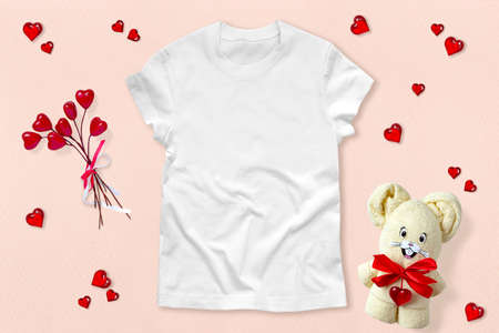 White T-shirt mockup on pink background with Valentine's Day decor. White cotton T-shirt mockup for design promotionの写真素材