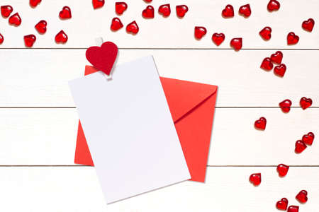 Blank card or invitation mockup with envelope and hearts for Valentines Day, wedding, etc.の写真素材