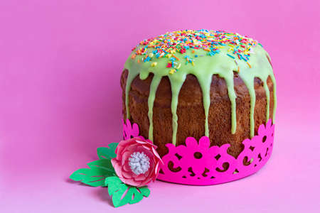 Bright Easter cake with green icing and colored sprinkles. Easter cake is wrapped with beautiful...