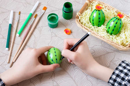 Making creative Easter decor from eggs. Colorful cacti from eggs for souvenirs and Easter designの写真素材