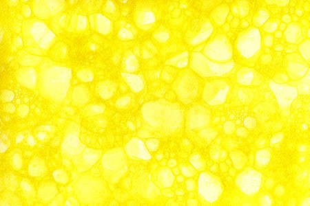 Abstract yellow background with stains of soap bubbles. Paper texture with effect of bubbles made by colored soap foam. Watercolor pattern for cards, prints, backgrounds, wallpapers and packagingの写真素材