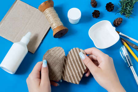 Making vintage decoration from packing cardboard for Christmas decor. Eco-friendly handmade decoration. Reuse, zero waste. DIY concept. Step by step photo instructions. Step 5 Remove top paper layerの写真素材