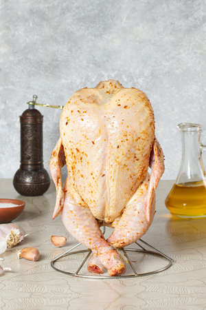 Raw chicken prepared for vertical grilling in the oven. Spices and seasonings necessary for chicken preparationの写真素材