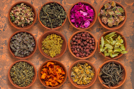 Dried, fermented herbs and fruits for herbal tea and herbal medicine in clay bowlsの写真素材