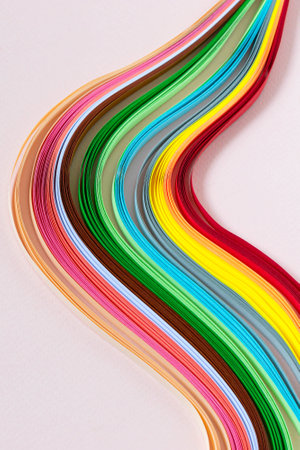 Abstract pattern of quilling stripes. Multicolored wave on pink paper backgroundの写真素材