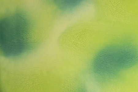 Abstract fabric background of rayon with shades of green color. Smooth fabric texture with ripple effect on surfaceの写真素材
