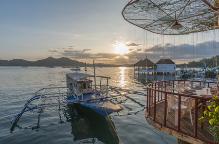 Traditional boat at terrace cafe at Coron Town at sunset view in Busuanga Island Palawan Philippines.のeditorial素材