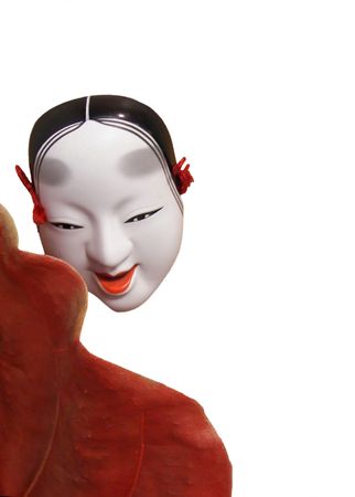 oriental mask with rust leaf on whiteの写真素材