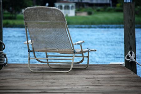 Summer chair at the end of the dock.の写真素材