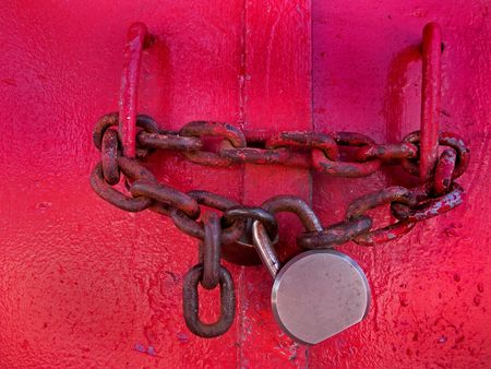 Rusty old chain and lock on lighthouse door.                               の写真素材