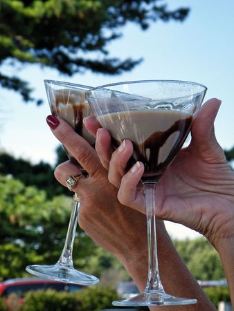 Chocolate martinis raised in a friendly toast.