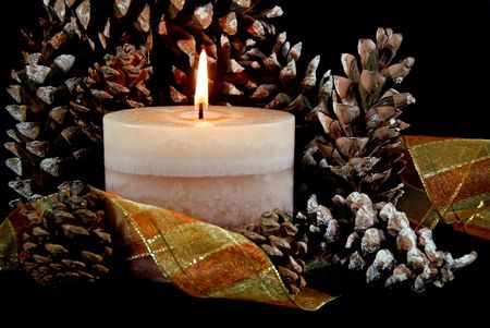 Auturmn ambiance with pine cones, candle and ribbon.の写真素材