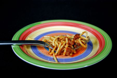 The last bite of a spaghetti dinner on a fork.