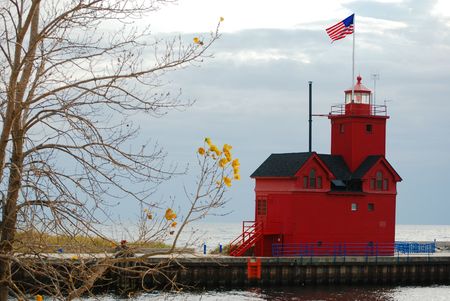Red lighthouse in autumn.の写真素材