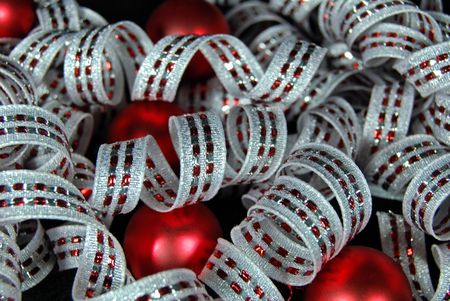 Fancy curly ribbon with red satin ornaments.の写真素材